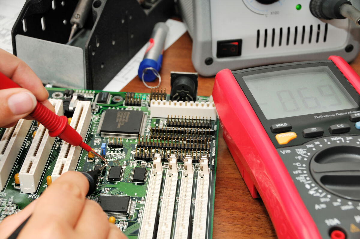 Technician testing a printed circuit board
