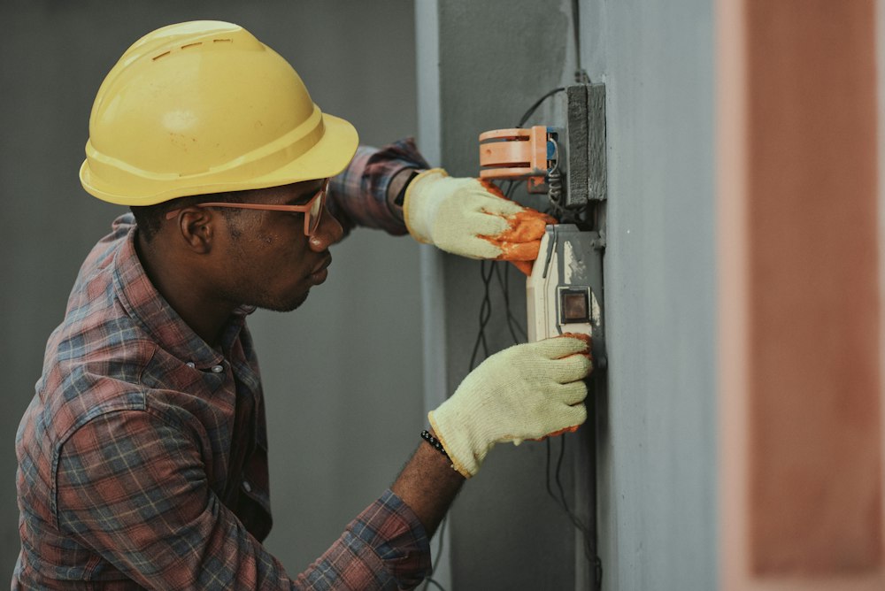 Worker in a safety helmet and protective gloves