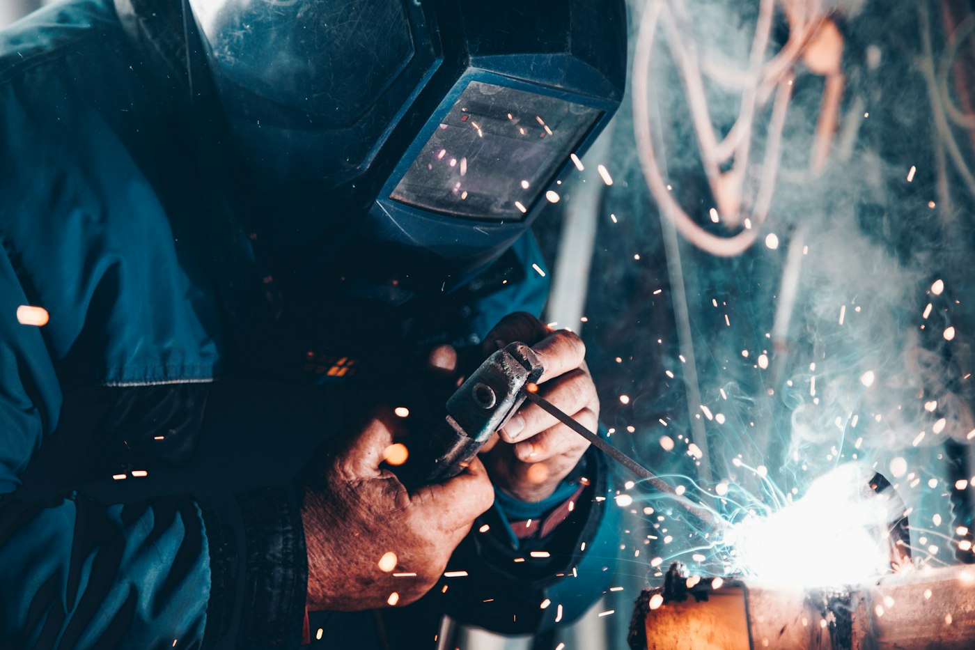 Welder in protective clothing and mask